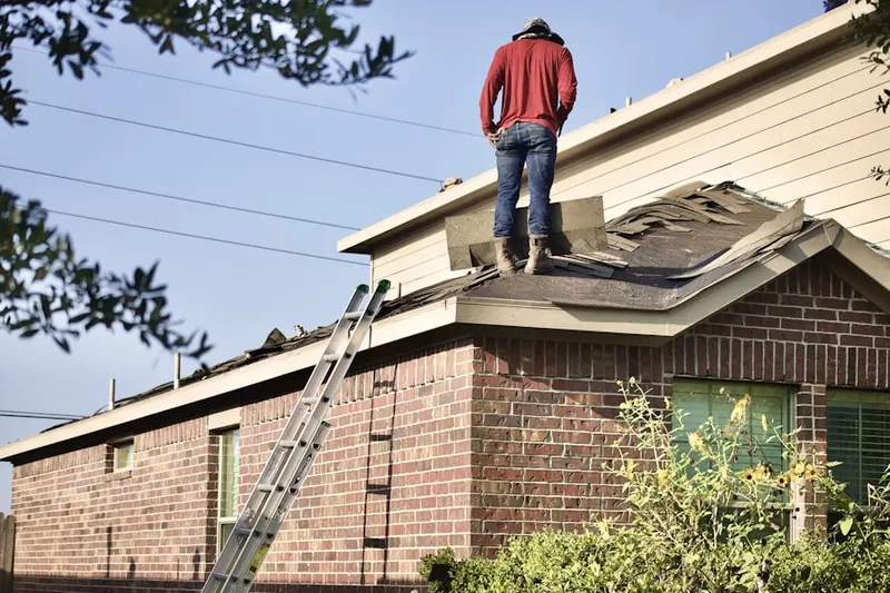 Professional roofer working on a residential roof in Mill Grove Gardens